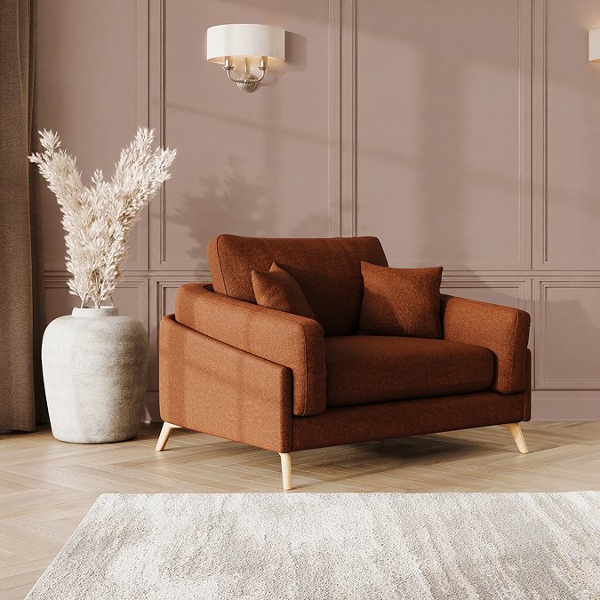 lifestyle image of snuggle chair with light oak feet in mandarin fabric