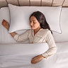 above image of woman resting head on king size pillow