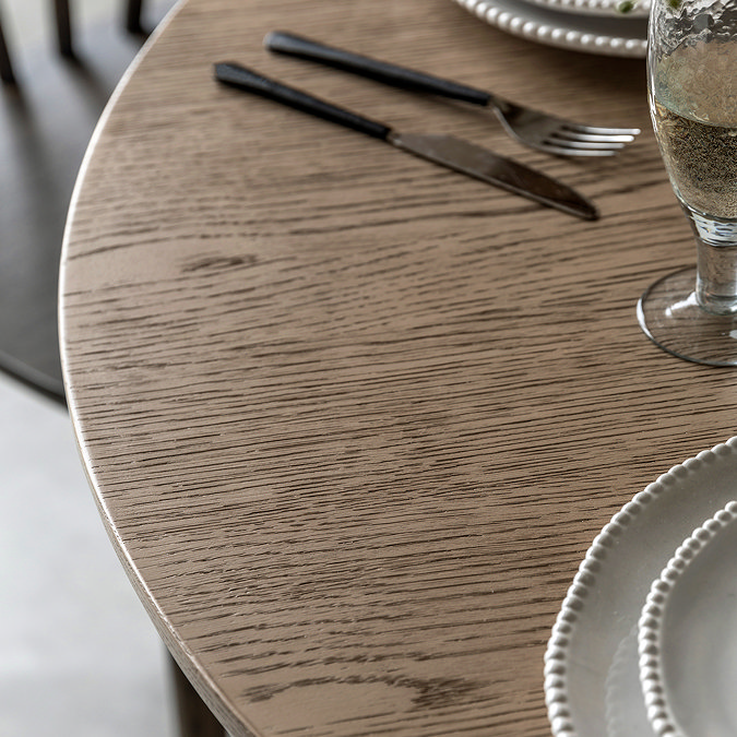 close up on smoked oak wooden surface of round dining table
