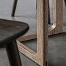 close up on legs of smoked oak dining table
