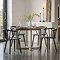 image of round smoked oak dining table with four dark brown wooden chairs