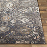 close up image of black floral rug laid on light wood flooring, highlighting floral pattern and soft texture