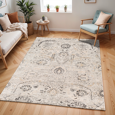 image of grey and ivory patterned rug folded over slightly to suggest thinness