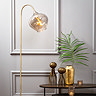 image close up on top of smoked glass and antique bronze floor lamp with curved over flower-bud head