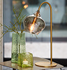 image of antique bronze and smoked glass table lamp on a side table