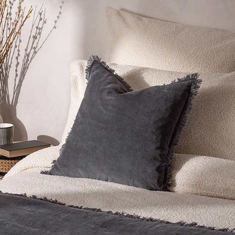 Jaye Cushion in slate on bed image 1