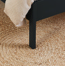 close up image of black feet of rattan double bed