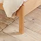 close up shot of oak bed with slim feet on light wooden floor