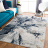 image of blue abstract marbled rug on light wood flooring in front of sofa