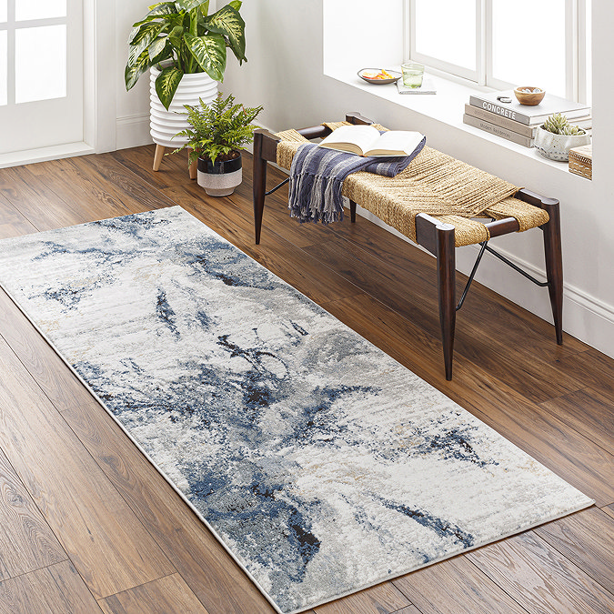 image of grey-blue abstract runner on wooden flooring