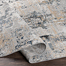 close up image of grey marbled abstract rug with shades of beige and blue