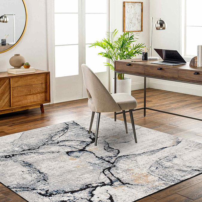image of grey abstract lined rug on wooden flooring of home office