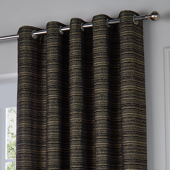 Jupiter Eyelet curtains in black and gold close up image