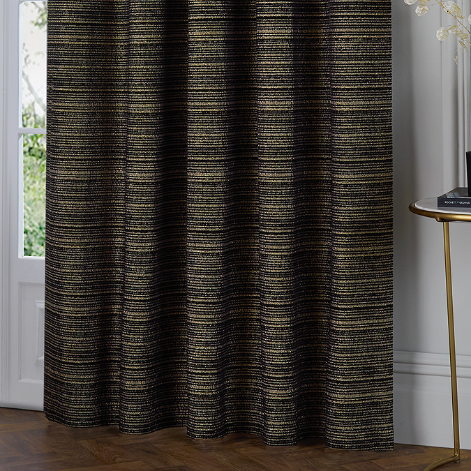 Jupiter Eyelet curtains in black and gold close up image