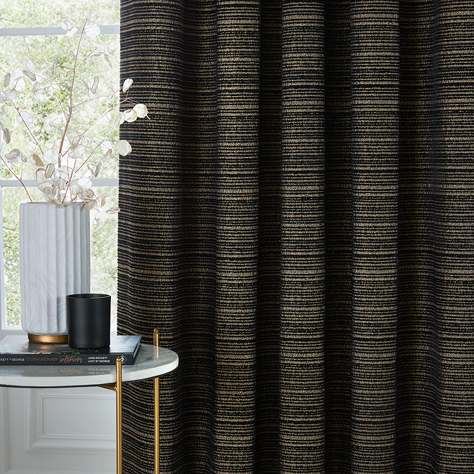 Jupiter Eyelet curtains in black and gold close up image