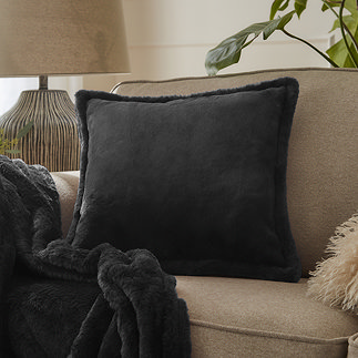 Kallu cushion in black on sofa image 1