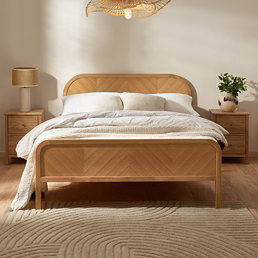 close up image of light oak wooden headboard with chevron pattern