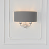 wall light with charcoal shade and 2 nickel coloured arms on cream wall