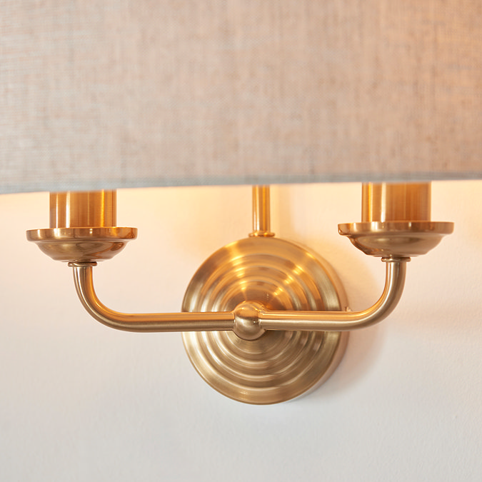 close up on vintage brass arms of wall light