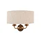 image cut out on white background of wall light with linen shade and 2 vintage brass coloured arms