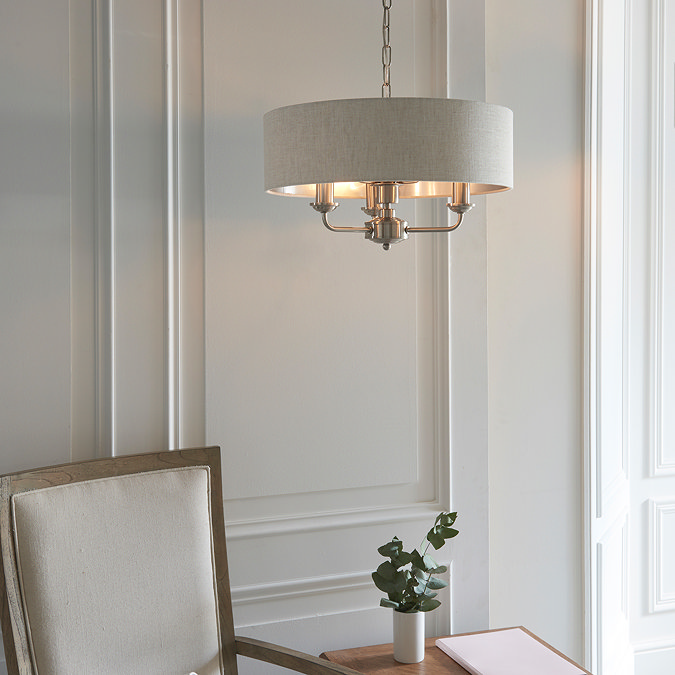 image of ceiling light in dining room with beige shade and chrome arms