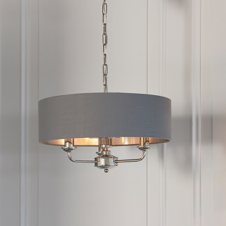 image of nickel framework light with three arms, with charcoal shade, in corner of dining room