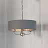 image of nickel framework light with three arms, with charcoal shade, in corner of dining room