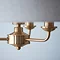 close up on brass metalwork of three arm pendant ceiling light