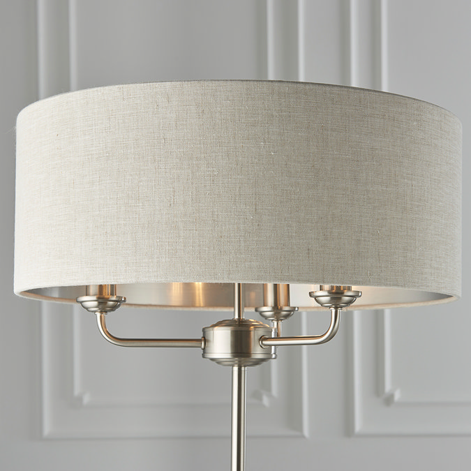 close up on natural shade of three arm chrome floor lamp