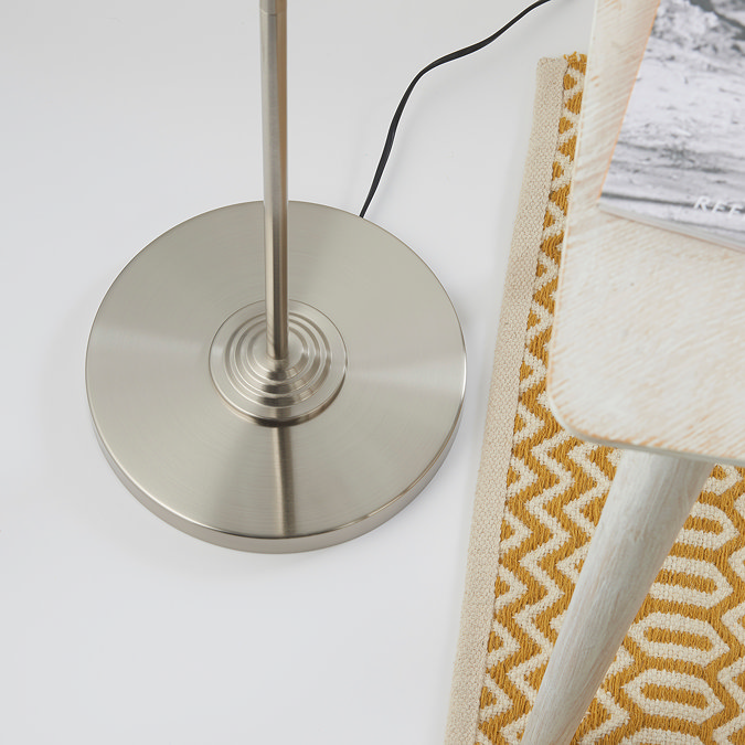 close up image taken from above of circular base of chrome floor lamp