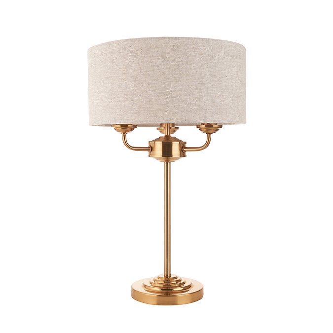 image cut out on white background of vintage brass lamp with natural shade