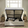 image of beige upholstered ottoman bed with top lifted up to show storage space inside