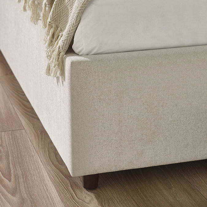 close up on upholstered material of beige footboard