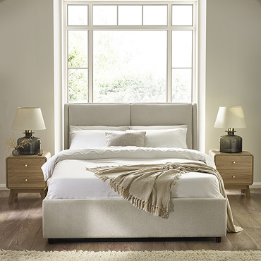 image of beige upholstered ottoman bed with top lifted up to show storage space inside