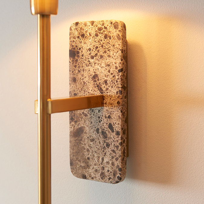 close up image on brown marble backplate of wall light