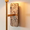 close up image on brown marble backplate of wall light