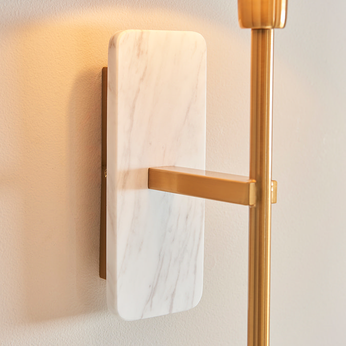 close up on white marble backplate of wall light