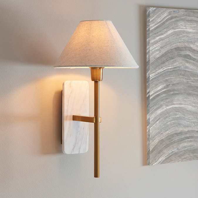 image of brass plated thin wall light with tapered shade and white marble backplate
