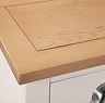 close up image of smooth light oak top of dressing table with pointed edge