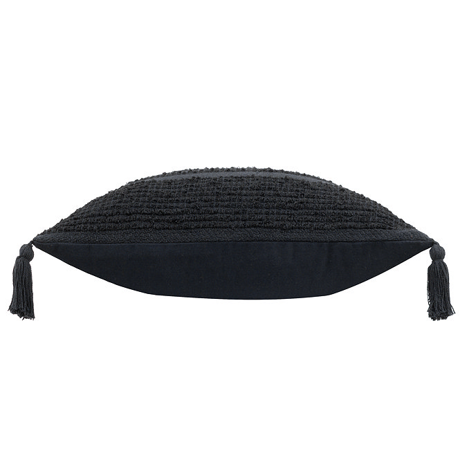 image cut out on white background of black tasselled cushion on its side to show its plumpness