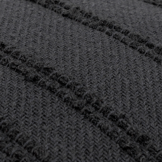 close up zoomed in image on black cushion with textured tuft stripes