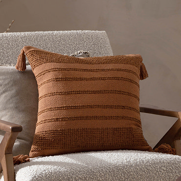close up image of dark orange tufted stripe cushion