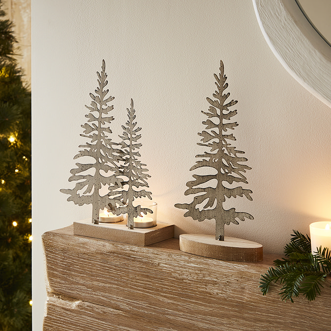 large rustic silhouette tree displayed on oak mantlepiece next to the double tree silhouette piece with tealights.