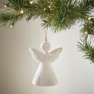 large white wood angel decoration, hanging from a christmas tree