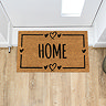 image of rectangular natural doormat with home written in the middle and hearts on the border, on wooden flooring in front of white door