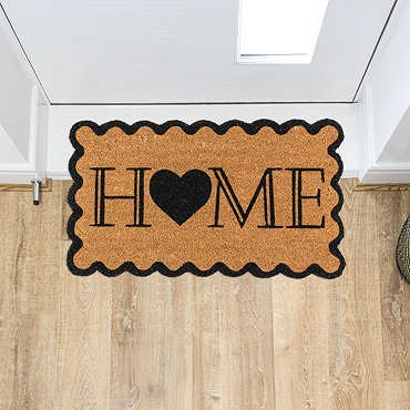 image cut out on white background of natural doormat with scalloped edges and home written in the centre
