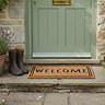 Welcome Doormat Lifestyle in front of Cottage Door