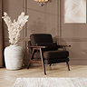 lifestyle image of mid-century brown velvet accent chair with warm wood frame