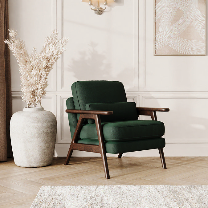 lifestyle image of hunter green velvet mid-century accent chair with warm wood frame