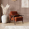 lifestyle image of mid-century velvet accent chair in umber, with warm wood frame